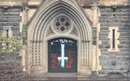 The graffiti on the doors of the Melbourne Cathedral made after the release of Cardinal Pell